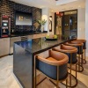 clubhouse kitchen with an island and stools