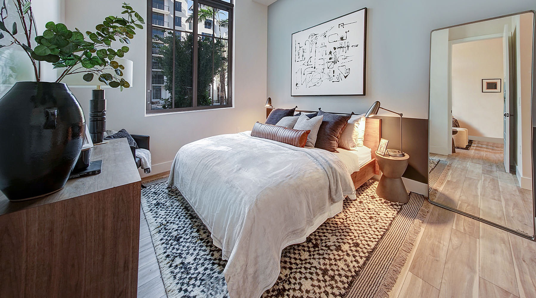 a bedroom with a bed and a plant