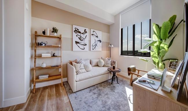 study room with a desk, couch and bookshelf